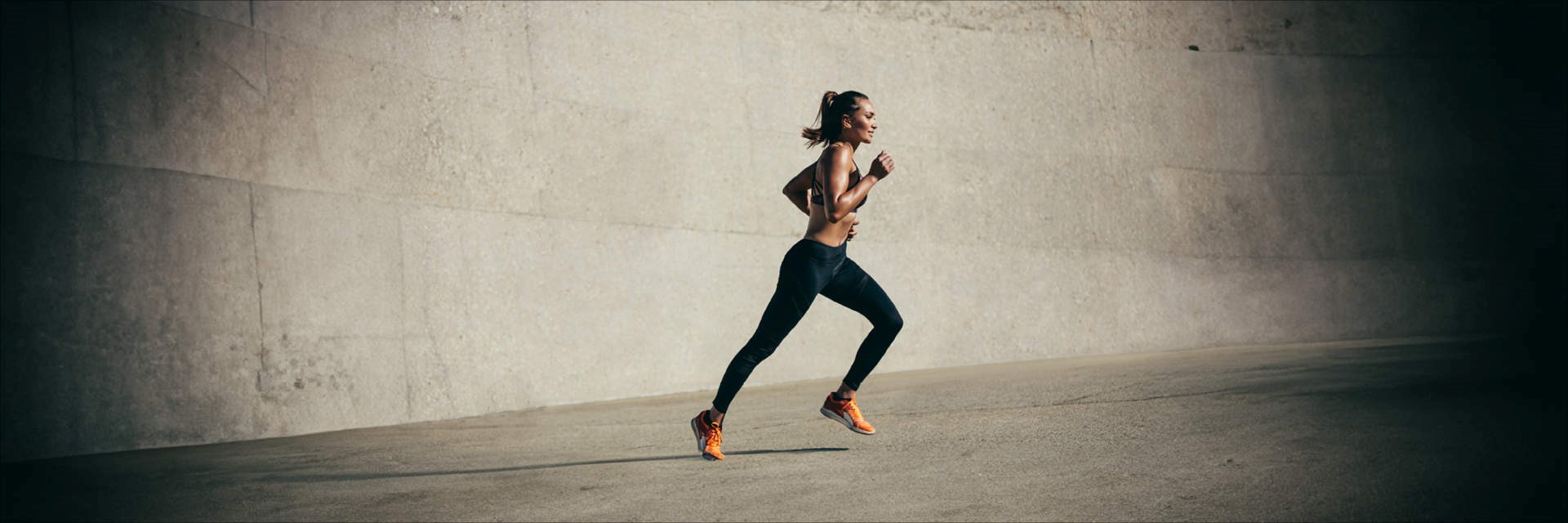 Woman exercising outside on concrete