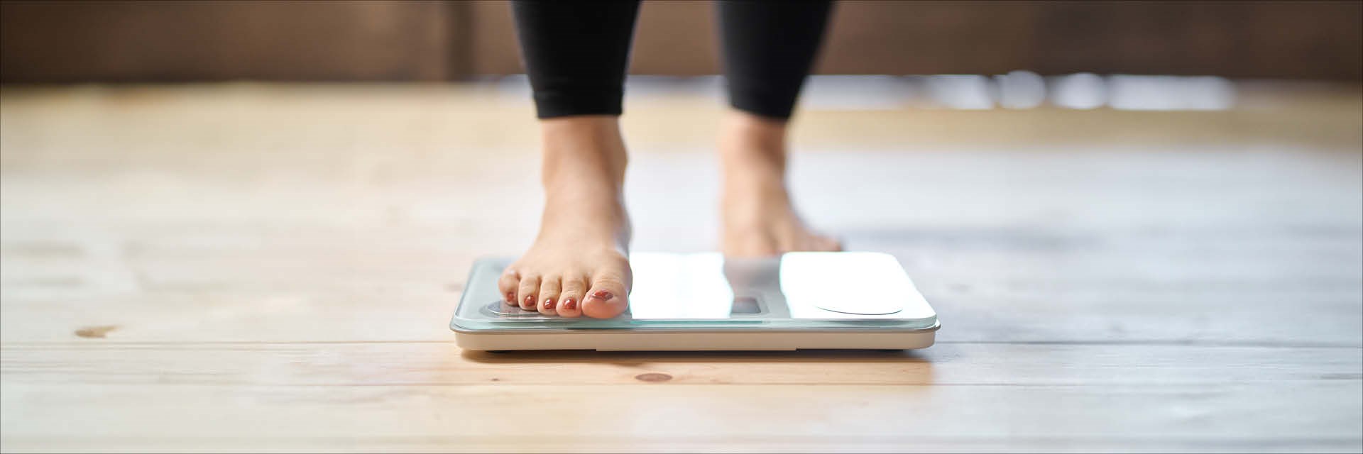 Barefoot person stepping onto scales