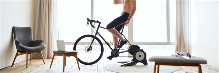 Cyclist on indoor trainer in their home